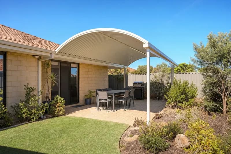 Dome patio with a curved steel roof over a paved entertaining area